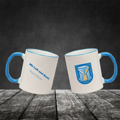Keramiktasse "Franzi" mit farbigen Henkel und Zunftzeichen und Spruch Tapezierer